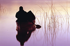 Silhouette man in a Canoe