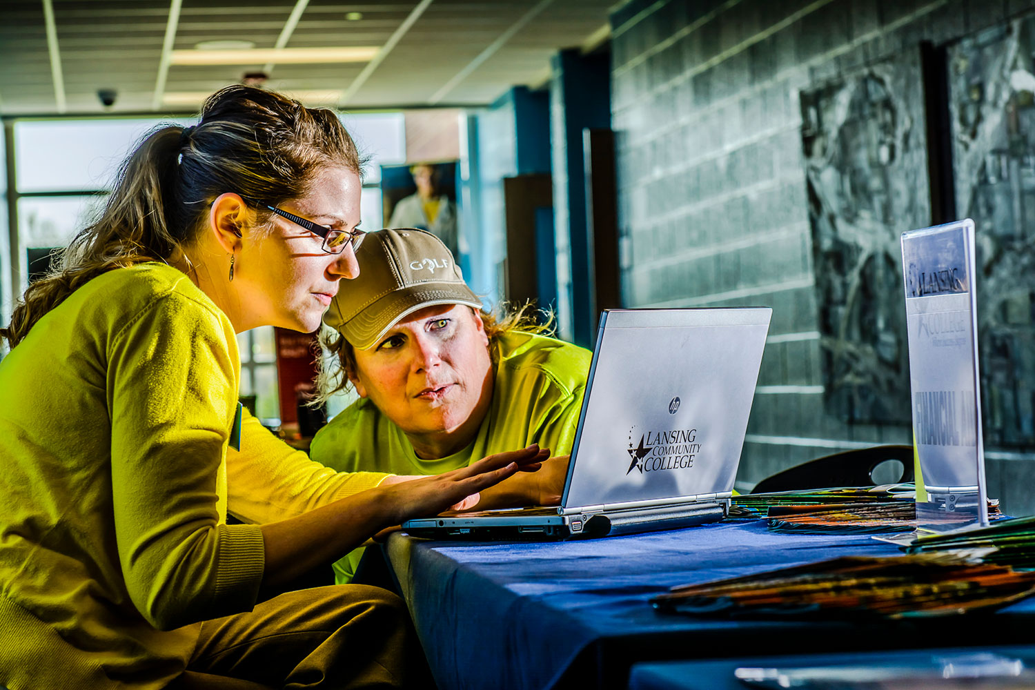 student and livcen employee looking at a laptop
