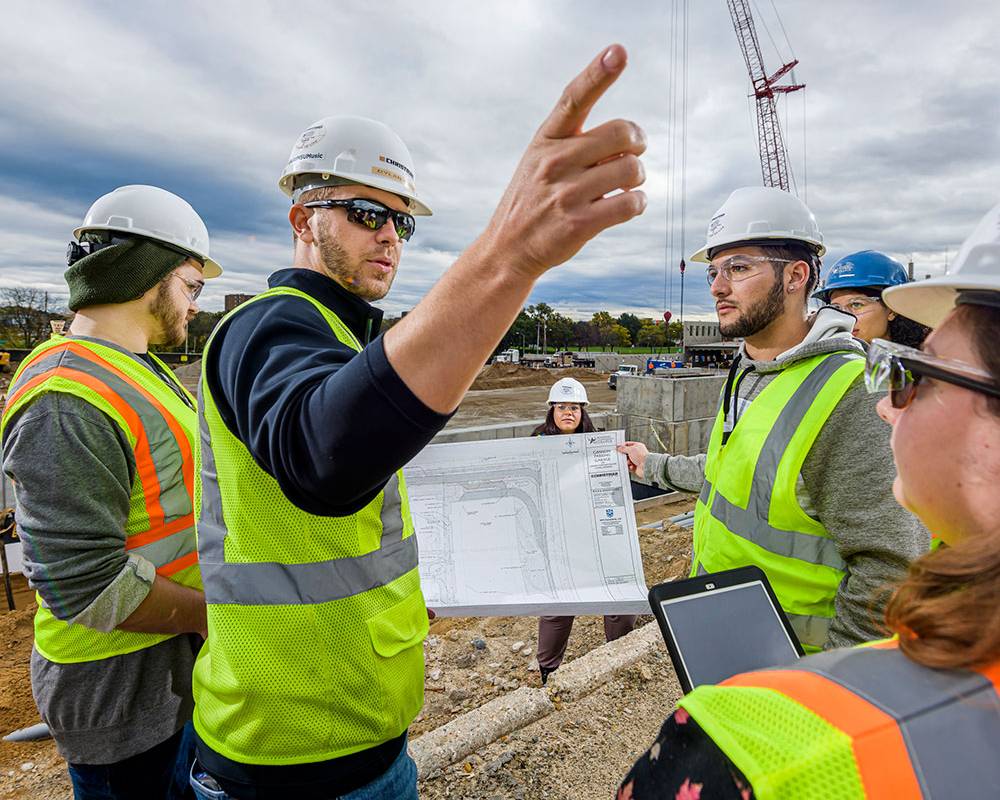 group discussing project outside at construction site