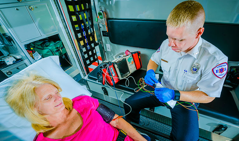 paramedic checking a patient's vital signs