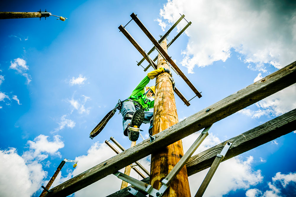 student up on one of the lcc training utility poles at west campus