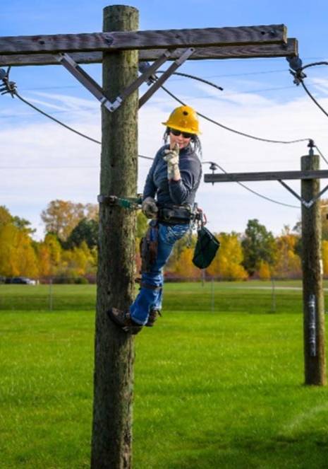 lineworker up on utility pole