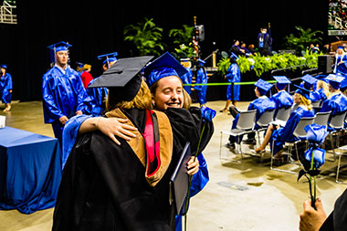 Graduate hugs her professor
