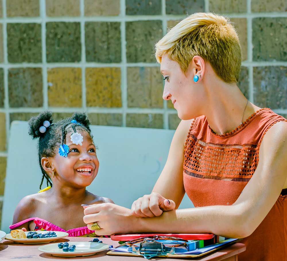 Women doing an activity with a child