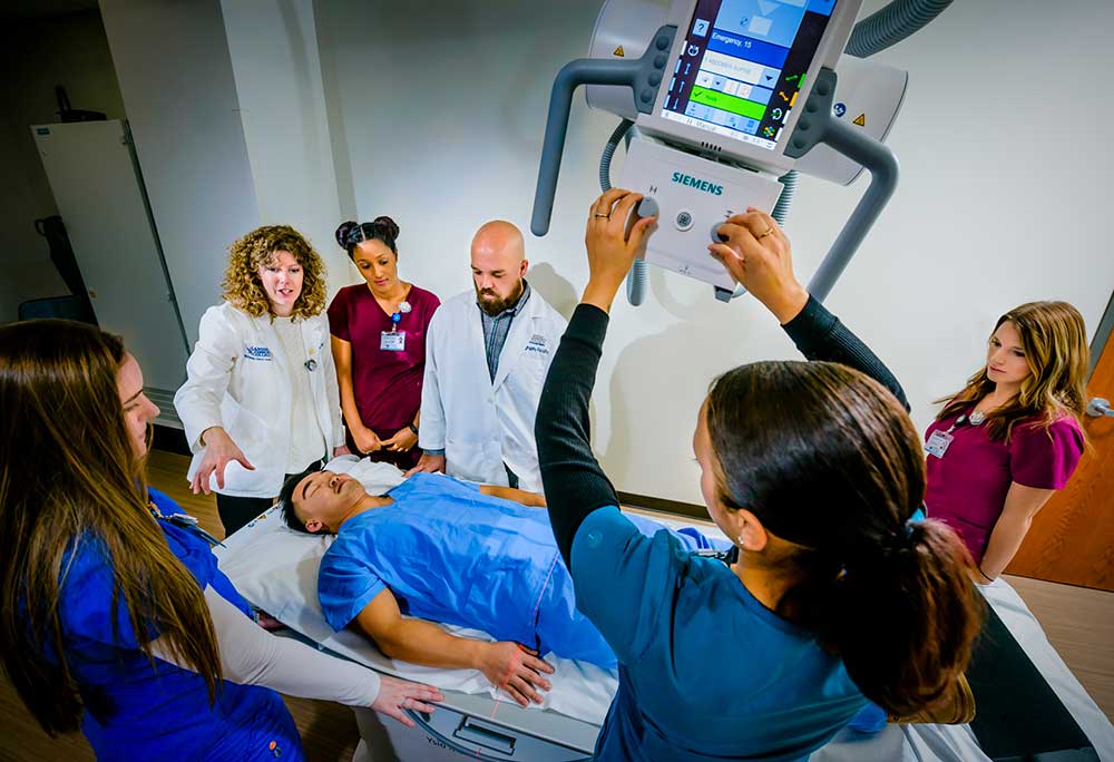 Group of students performing an x-ray on another student