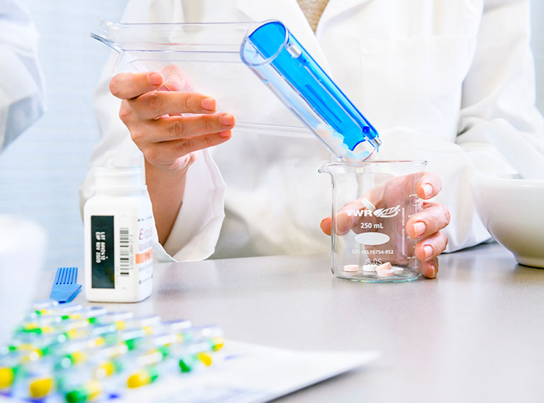 person mixing prescription pills
