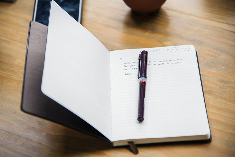 open book with pen on top