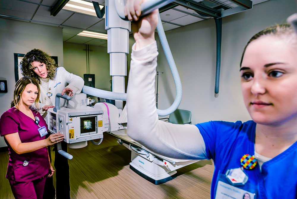 Group of students performing an x-ray on another student