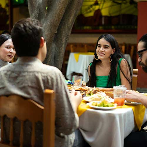 People in conversation at a restaurant.