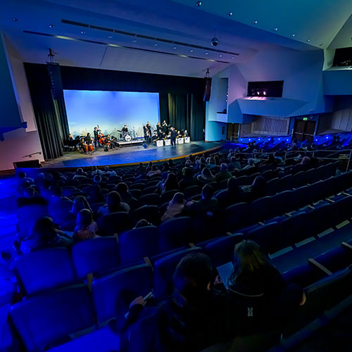 Theatre with audience watching performance.