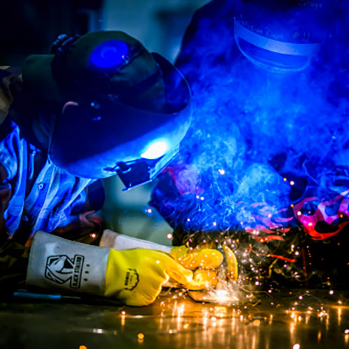 Two people welding