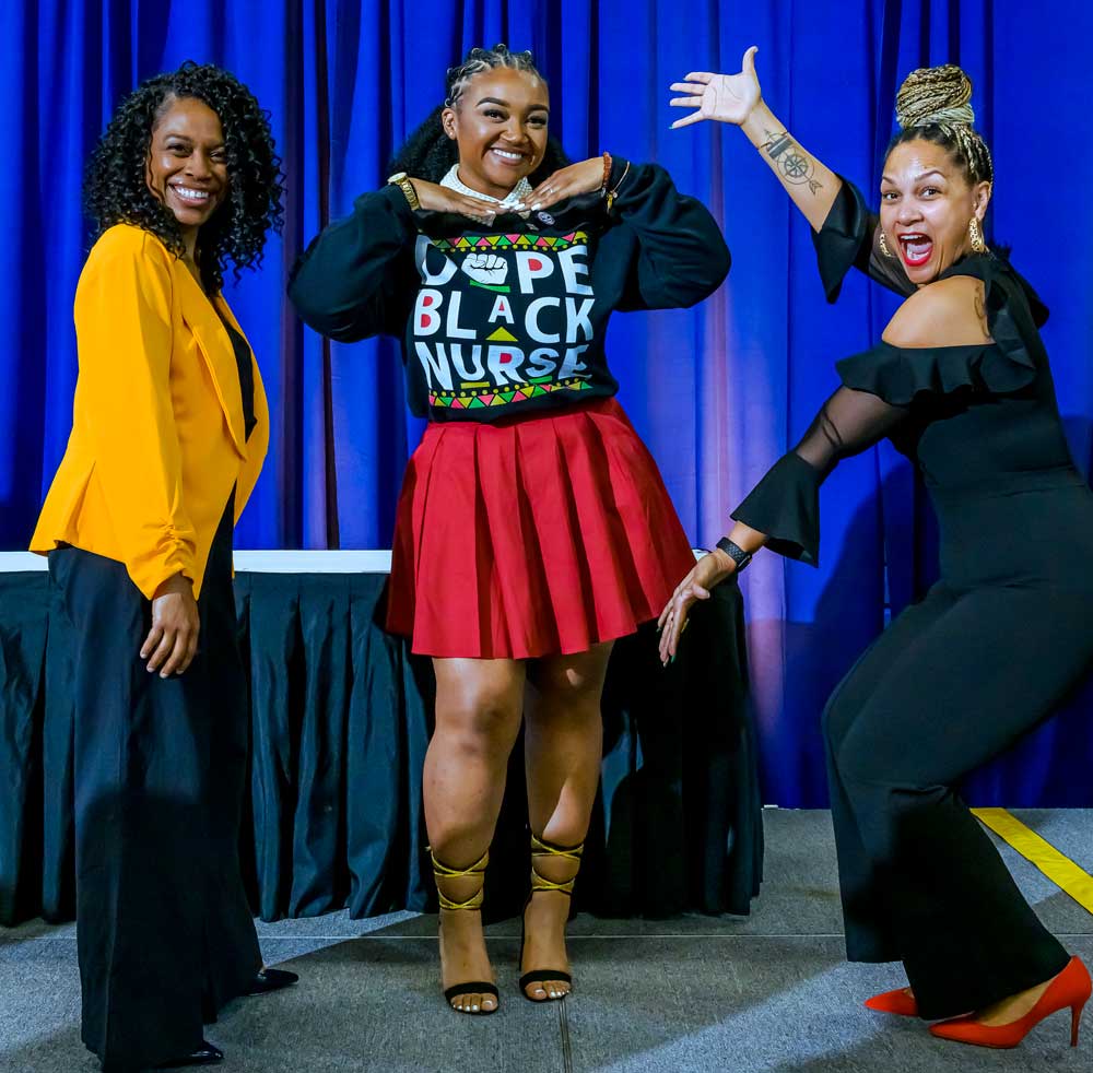 Two instructors celebrating with a student.