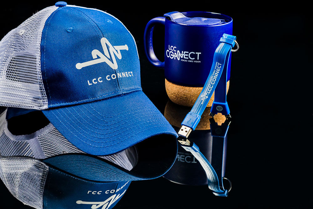lcc connect branded swag items including a hat, mug, and thumb drive