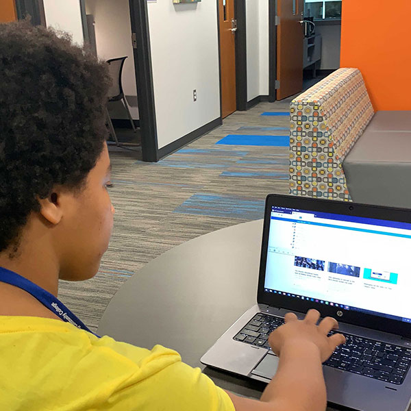 Student typing on computer