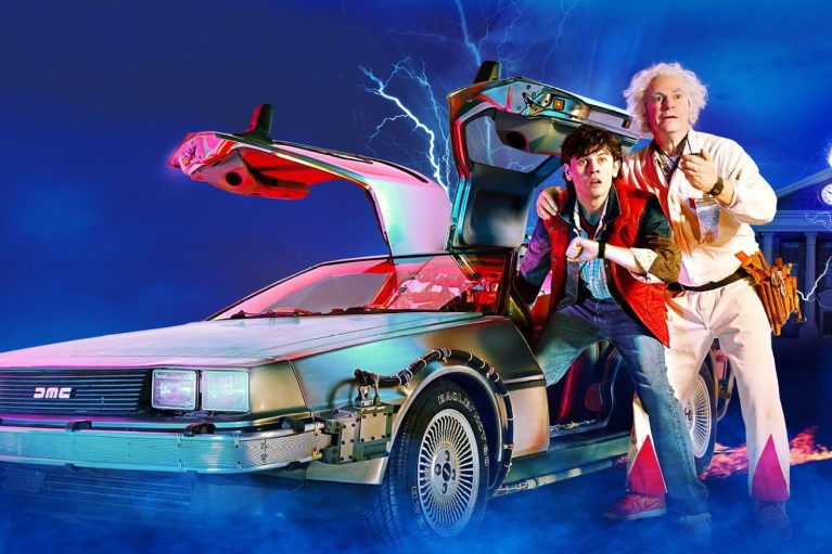 Marty McFly and Doc Brown next to a time-travel modified Delorean