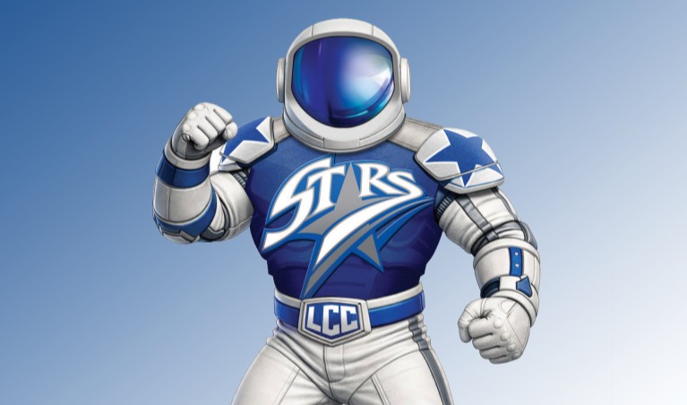 Students engage in a conversation while looking at a laptop in a classroom.