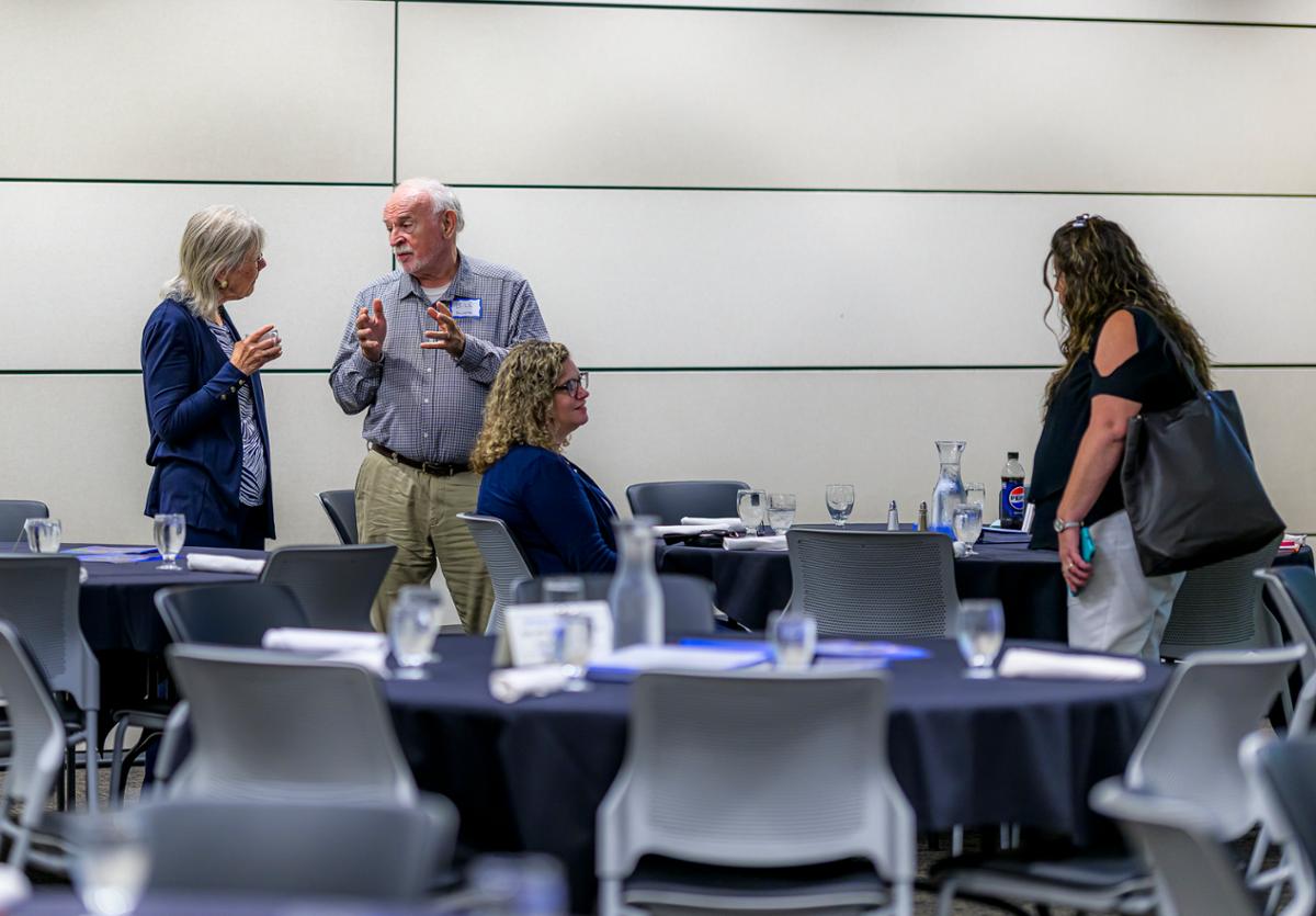 A group of people around a table talking