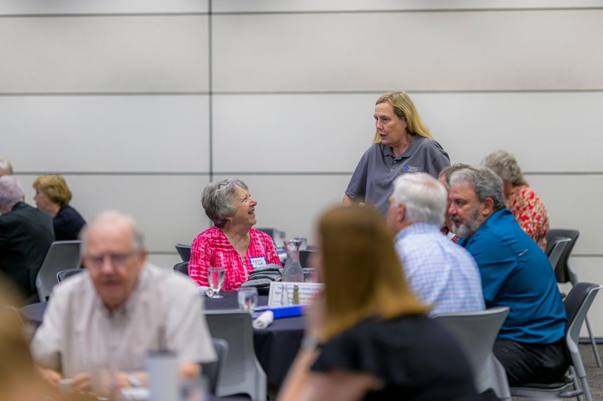 Two people around a table talking