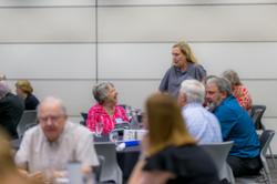 Two people around a table talking
