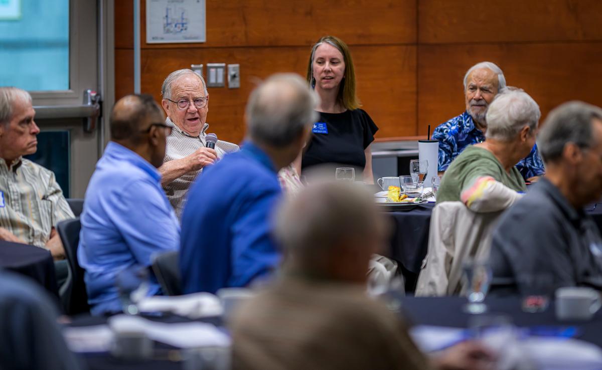 A Group of people listening to audience member speak