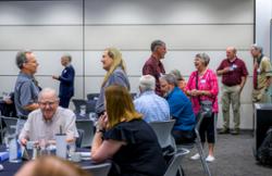 A group of people around a table talking.