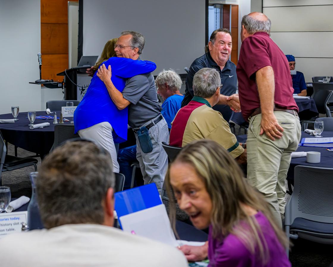 A group of people around a table talking.