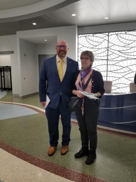 Anita Lees holding her award at her 25 year service award ceremony - she is joined by bill garlick, CIO 
