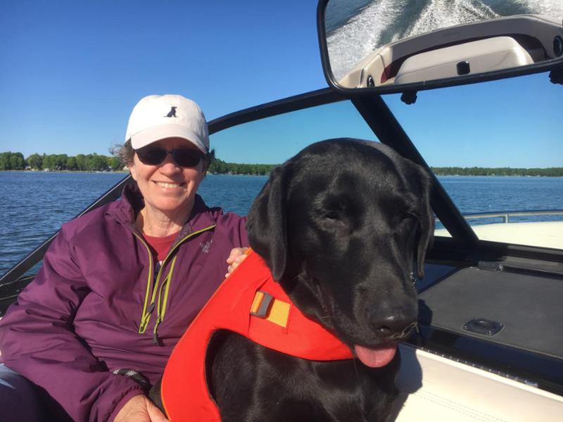Erica Staton in a boat with her dog