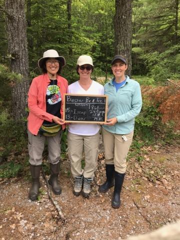Erica Staton holding a sign with two other women