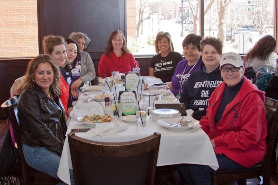 Eva Menefee at a table with other women