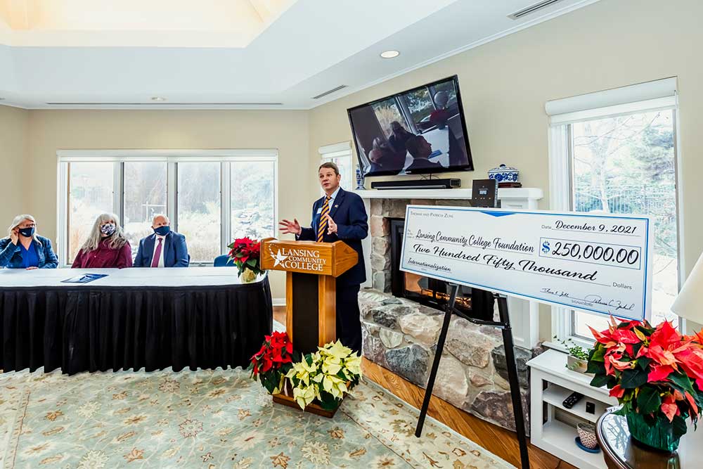 dr. robinson speaking at a foundation check presentation