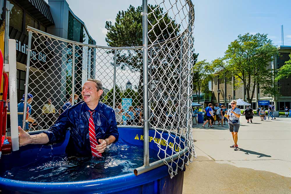 dr. robinson laughing after being dunked in a dunk tank
