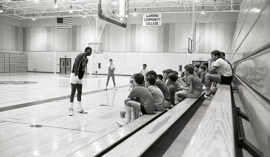 Young students and coaches listen to a speaker at a basketball camp held in the Gannon Gymnasium - ca. 1980s
