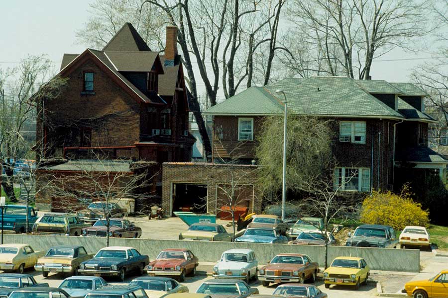 The back (or west) side of the Rogers-Carrier House (left) and North House (right) that sat along Capitol Avenue - ca. 1973. The Rogers-Carrier House is a Historic landmark in the City of Lansing and is currently undergoing exterior weatherproofing improvements to maintain the building.