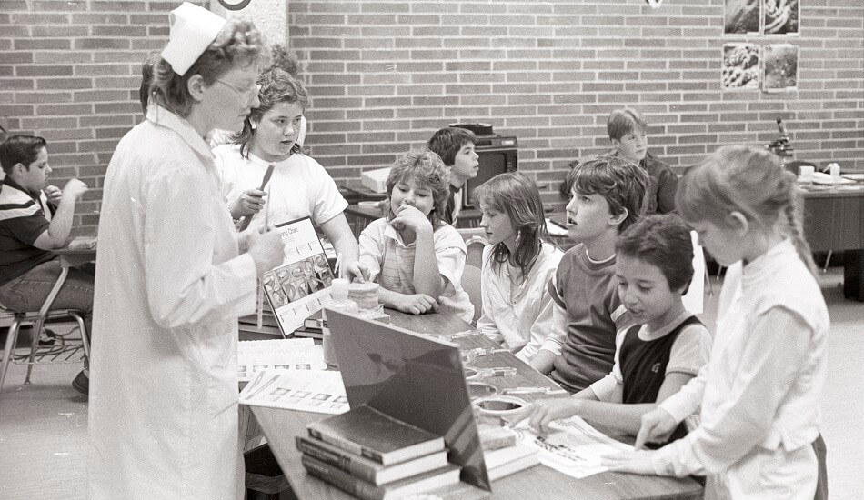 Students at the dental hygiene table at the Early Elementary Science Olympiad (ESO) event held in the old LSARC (Liberal Studies Academic Resource Center) which was on the 4th floor of the Arts & Sciences Building - ca. 1988-1994