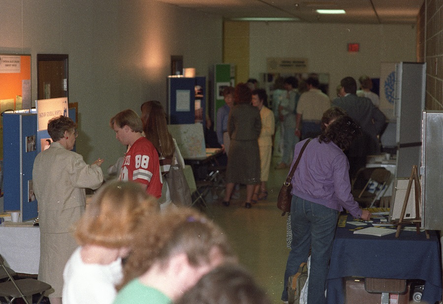 Students visit vendor tables at a Health Careers Fair on campus  - ca. 1980s
