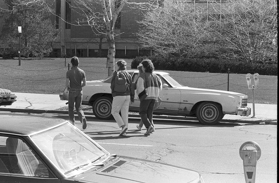 Students walk across Capitol Avenue with the Arts & Sciences Building in the background - ca. 1980s