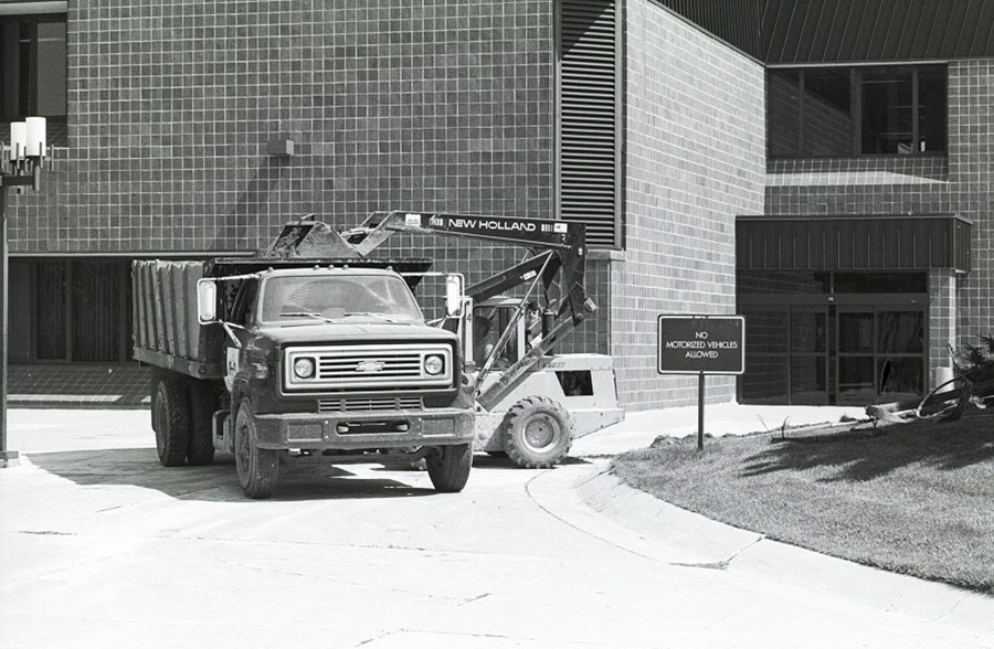 Construction vehicles parked next to a "No Motorized Vehicles Allowed" sign outside the Gannon Building - ca. 1980s