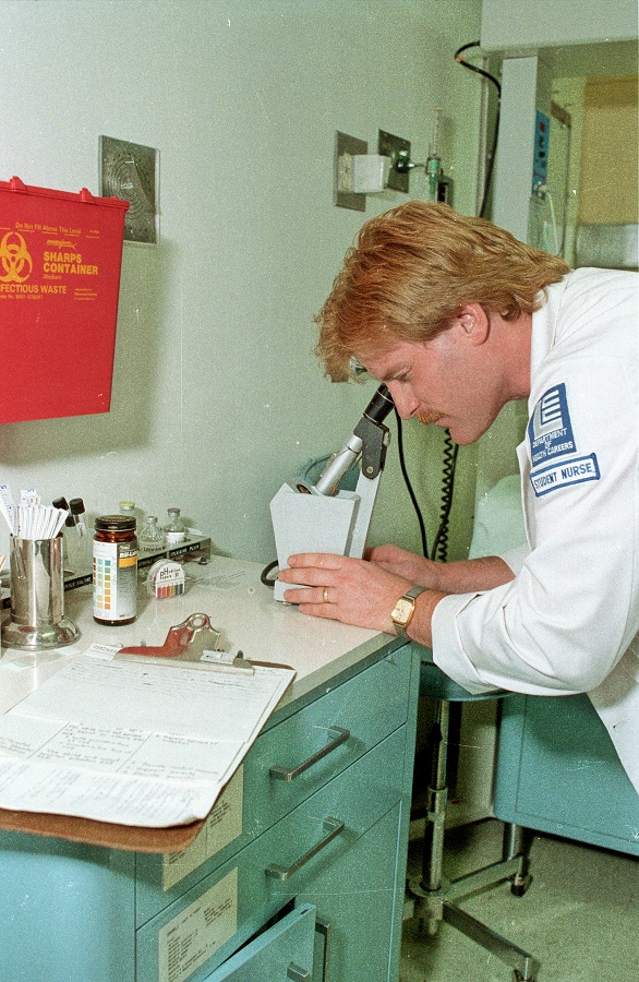 A Student Nurse from the LCC Department of Health Careers looks through a microscope - May 1988