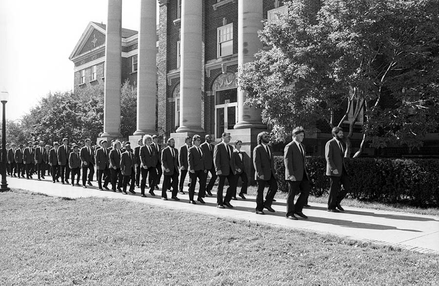 Graduates of the Corrections Program, a part of the Criminal Justice Systems Department in the Division of Business, walk to their graduation ceremony, ca. 1980s. LCC's Corrections Officer Academy is now a part of the Job Training Center in the Community Education and Workforce Development Division.