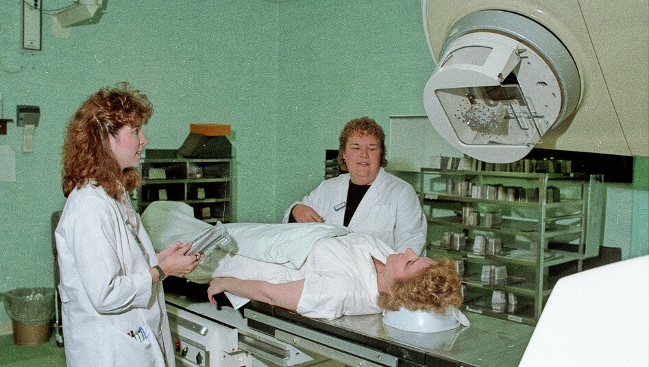 A Radiologic Technology Student from the LCC Department of Health Careers and an instructor operate equipment over a patient - May 1988