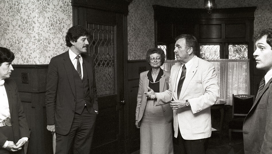 President Philip Gannon and others in the front room of the Herrmann House - ca. 1980s