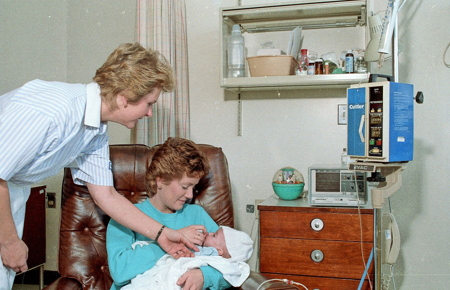 A Student Nurse from the LCC Department of Health Careers attends to a woman and a baby - May 1988