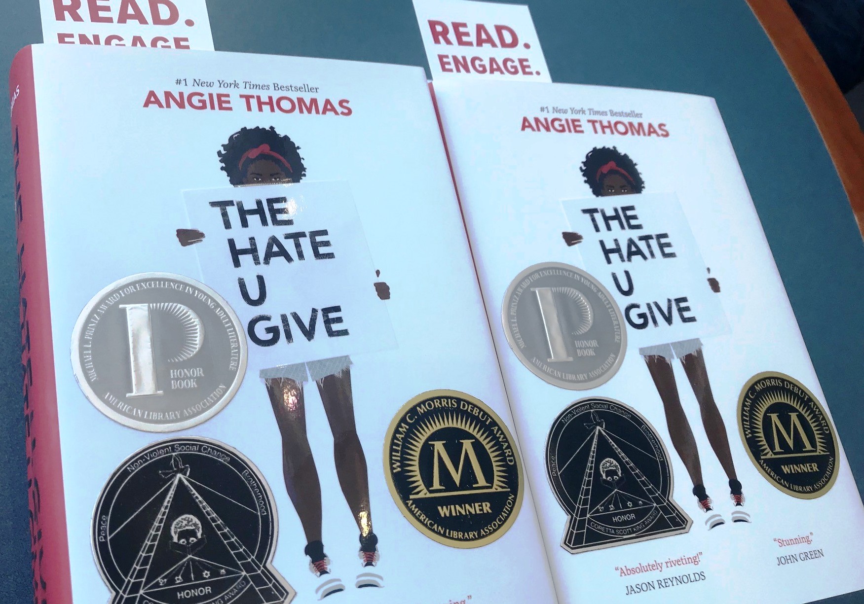 two copies of Angie Thomas' book "The hate u give"