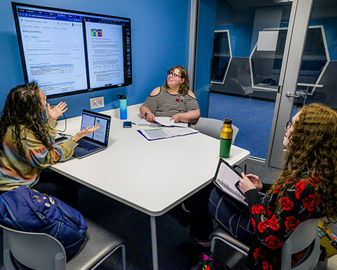 study room with a table and a large monitor