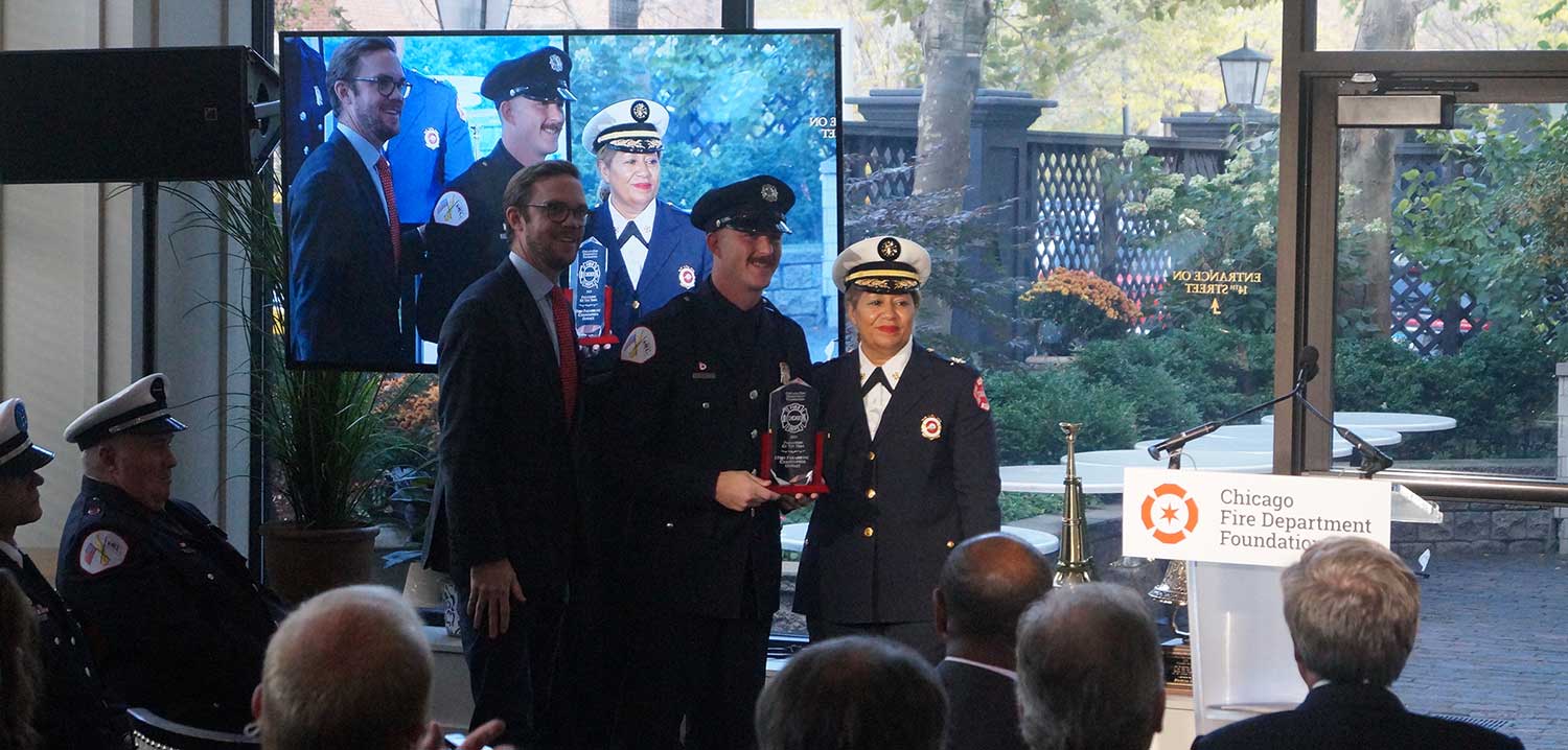Chris Oswalt being honored with the Chicago Fire Department Paramedic Award for Valor and the Chicago Fire Department Paramedic of the Year Award
