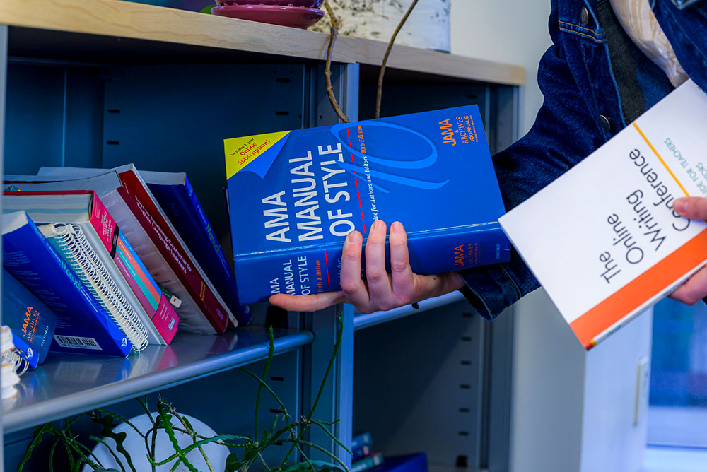 a closeup of a hand holding two ap style books