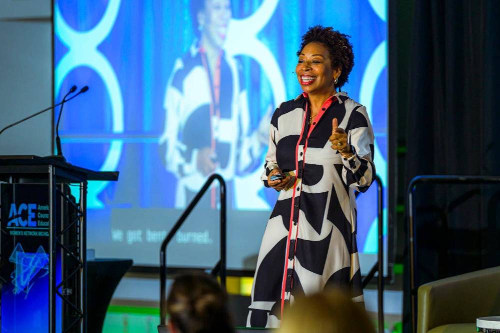 a speaker at the podium on stage speaking